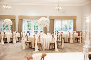 a conference room with tables and chairs and chandeliers at Delta Hotels by Marriott Preston in Preston