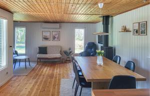 a living room with a wooden table and chairs at Gorgeous Home In Læsø With Wifi in Læsø