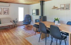 a living room with a wooden table and chairs at Gorgeous Home In Læsø With Wifi in Læsø