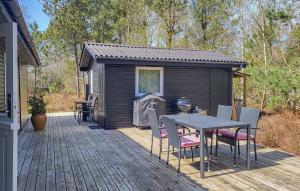 a table and chairs on a deck with a shed at Gorgeous Home In Læsø With Wifi in Læsø +11 photos