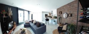 a living room with a couch and a brick wall at Sweet Dreams in Visé
