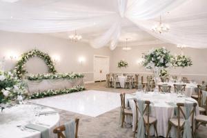 a wedding banquet room with white tables and flowers at Delta Hotels by Marriott Preston in Preston +63 photos