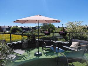 a patio with a table and chairs and an umbrella at Sweet Dreams in Visé
