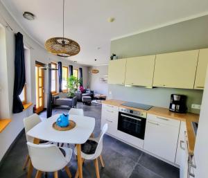 a kitchen and living room with a table and chairs at Heideberg Appartement in Zeuthen