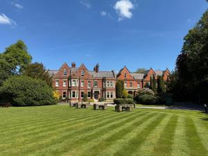 a large building with benches in the middle of a lawn at Delta Hotels by Marriott Preston in Preston