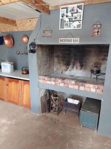 a kitchen with a brick fireplace in a house at Cozy Corner Unit 1 and unit 2 in Bredasdorp