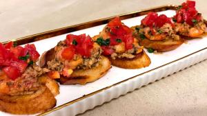 a plate of food with meat and tomatoes on it at The 5th Element Boutique Hotel in Paje +117 photos
