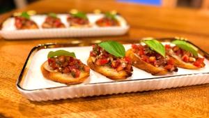 four small appetizers on a plate on a table at The 5th Element Boutique Hotel in Paje