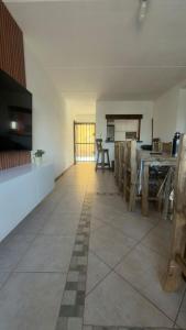 a large room with a table and a kitchen at Hostel All inclusive in Zárate +21 photos