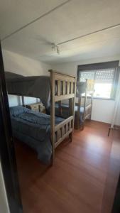 a bedroom with a bunk bed and a table at Hostel All inclusive in Zárate