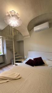 a bedroom with a bed with a ceiling with a staircase at Dimora del Loggiato in Acqui Terme