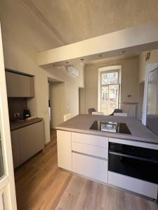 a kitchen with a stove and a counter top at Dimora del Loggiato in Acqui Terme