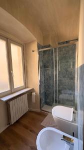 a bathroom with a shower and a toilet and a sink at Dimora del Loggiato in Acqui Terme +36 photos