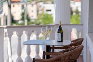 a table with two glasses and a bottle of wine at Art Boutique Hotel Berat in Berat