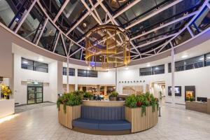 a lobby with a large chandelier in a building at Crowne Plaza Liverpool City Centre by IHG in Liverpool +144 photos