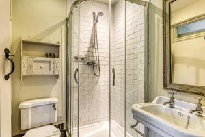 a bathroom with a shower and a toilet and a sink at Apple Cottage in Snowshill +26 photos
