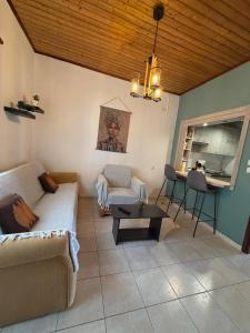 a living room with a couch and a table at Olive tree villa in Ligia