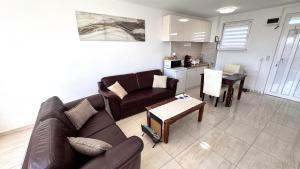 a living room with a couch and a table at Rest House Apartman in Nyíregyháza