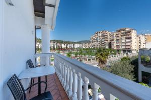 a balcony with chairs and a view of a city at Art Boutique Hotel Berat in Berat
