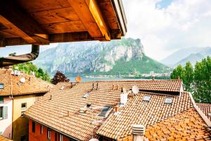 a view of roofs of buildings with mountains in the background at Villa Maggie on Lake Como in Malgrate