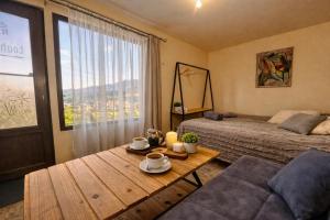 a room with two beds and a table with coffee cups at TEVRA Nature, Retreat Mountain Cabins Above the City Ijevan, Dilijan in Ijevan +45 photos