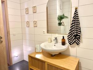 a bathroom with a sink and a mirror at 2 Unique Apartments in the Historic Center in Straubing +28 photos
