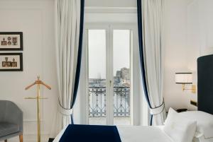 a hotel room with a bed and a window at Grand Hotel Santa Lucia in Naples