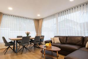 a living room with a couch and a table at Sunset Pool Villa Ao Nang Krabi in Ao Nang Beach