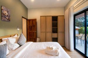 a bedroom with a bed with a towel on it at Sunset Pool Villa Ao Nang Krabi in Ao Nang Beach +46 photos