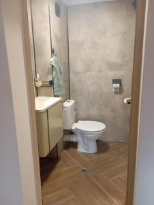 a bathroom with a white toilet and a sink at Apartments Provence in Sozopol +47 photos