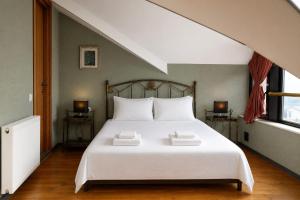 a bedroom with a bed with two towels on it at Hilltop Kazbegi in Kazbegi