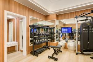 a gym with several treadmills and exercise equipment at Grand Hotel Santa Lucia in Naples