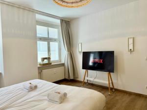a bedroom with a bed with a tv in it at 2 Unique Apartments in the Historic Center in Straubing