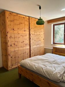 a bedroom with a bed and a wooden wall at Mountainview Flattnitz in Flattnitz