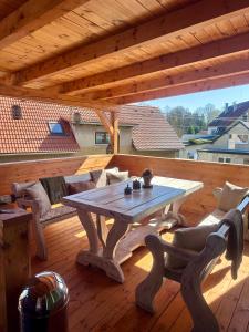 a wooden deck with a table and chairs on a patio at Restaurace a penzion u Kulíků in Raspenava +30 photos