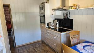 a small kitchen with a sink and a stove at Apartment Wildgrund in Siegen