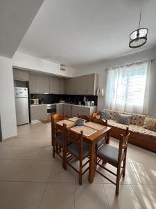 a kitchen and dining room with a table and chairs at Margaret's Guest House in Mesopotam