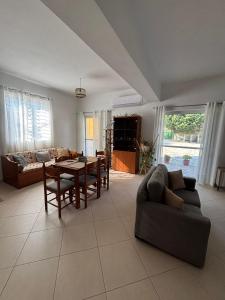 a living room with a couch and a table at Margaret's Guest House in Mesopotam