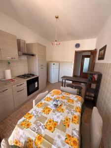 a kitchen with a table with a quilt on it at Casa di Mary in Pontremoli
