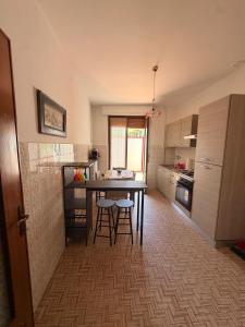 a kitchen with a table and chairs in a room at Casa di Mary in Pontremoli +6 photos