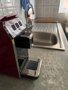 a toaster sitting on a kitchen counter next to a sink at Bloom House Përmet in Përmet
