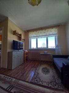 a living room with a large window and a couch at Peatuspaik Paides in Paide
