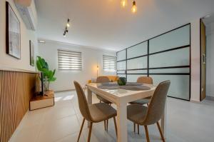 a dining room with a table and chairs at The Oasis - R4 in Senglea