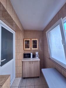 a small kitchen with a microwave and a window at L.M. in Sulina +6 photos