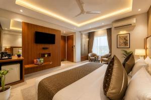 a hotel room with a bed and a television at Corporate Terminal Stay By Velocity Hotels Delhi IGI Airport Terminal 3 With Free Airport Pickup in New Delhi