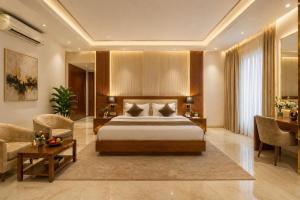 a hotel room with a bed and a desk at Corporate Terminal Stay By Velocity Hotels Delhi IGI Airport Terminal 3 With Free Airport Pickup in New Delhi