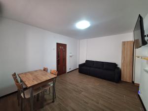 a living room with a table and a couch at L.M. in Sulina