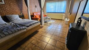 a bedroom with a bed and a brick wall at Apartment Wildgrund in Siegen