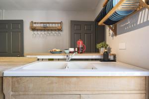 a kitchen with a large white sink in a kitchen at Ace Cottage in Lymington +50 photos