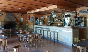a restaurant with tables and chairs and a bar at Scopa Rossa in Evisa